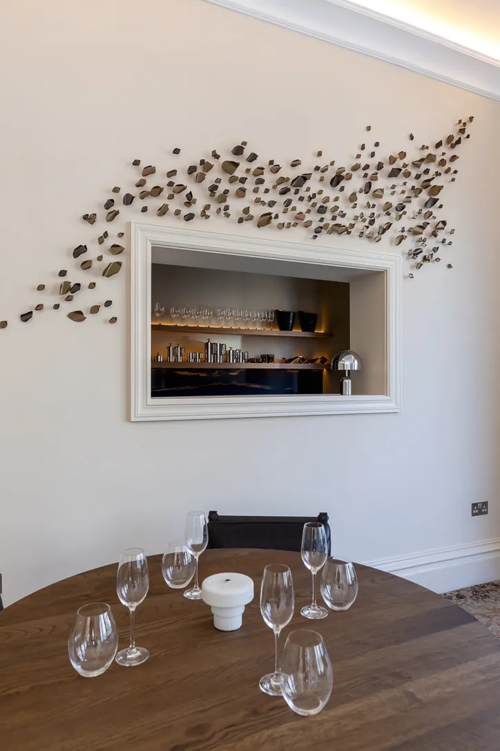 Wall sculpture around a lit serving hatch in the ROH Day Spa Lounge