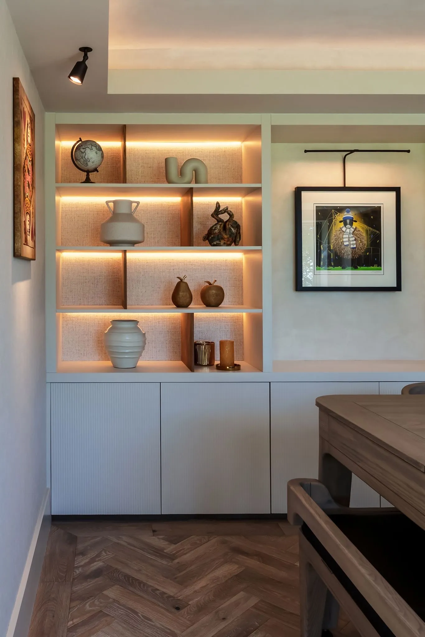 Arkendale, shelving and framed art beside a herringbone floor