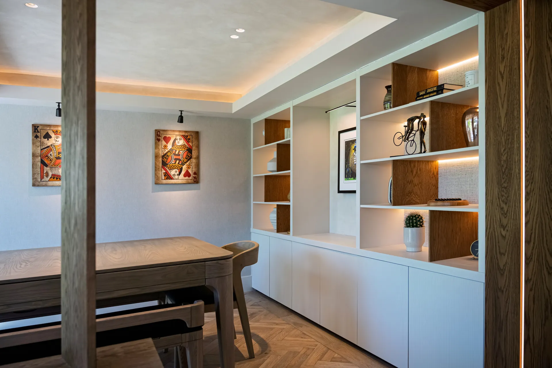 Living space with a long table and built-in shelving, Arkendale, North Yorkshire, interior design by Dean Heim & Co.