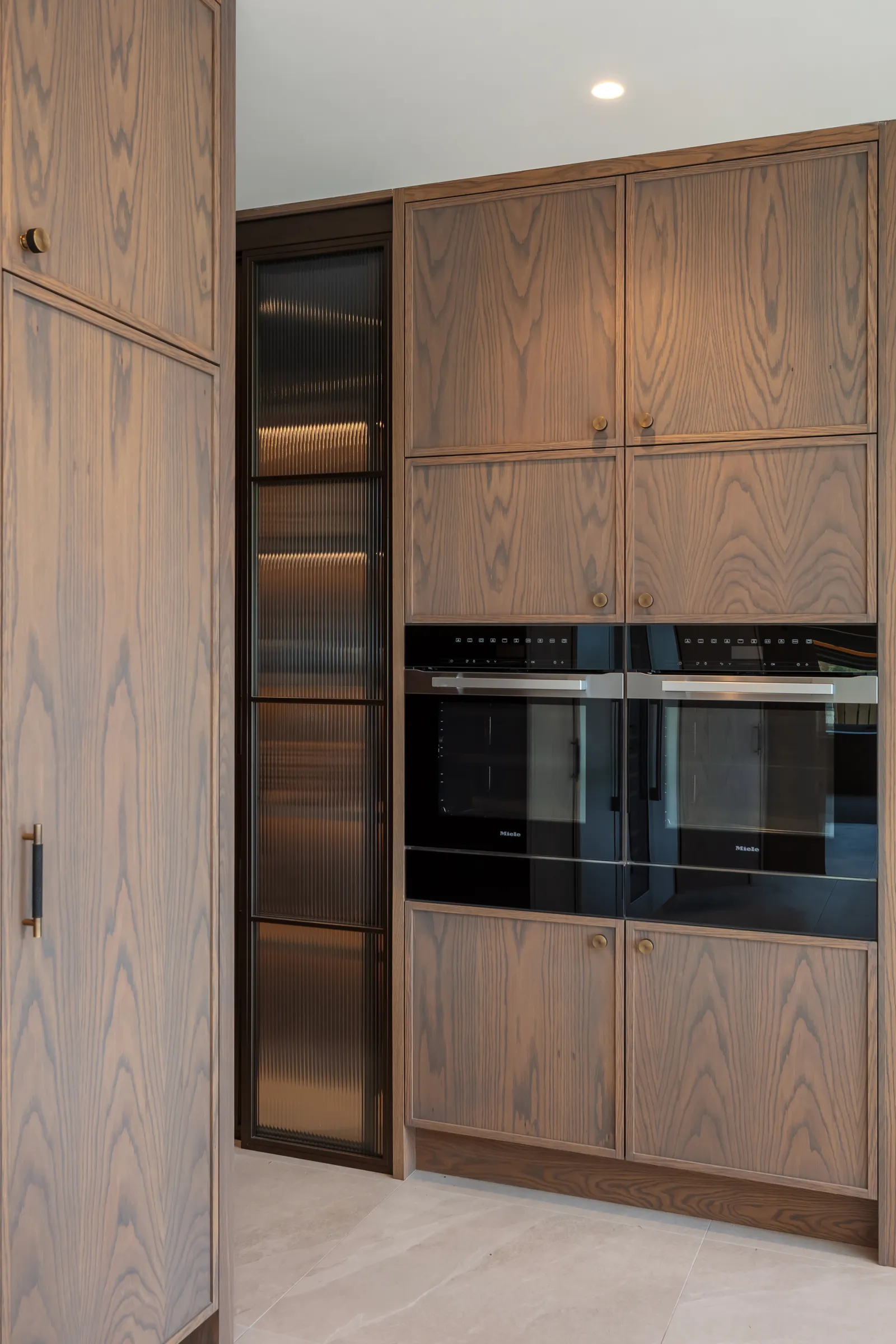 Elmtree Manor, tall oak kitchen cabinetry with built-in ovens, Askwith