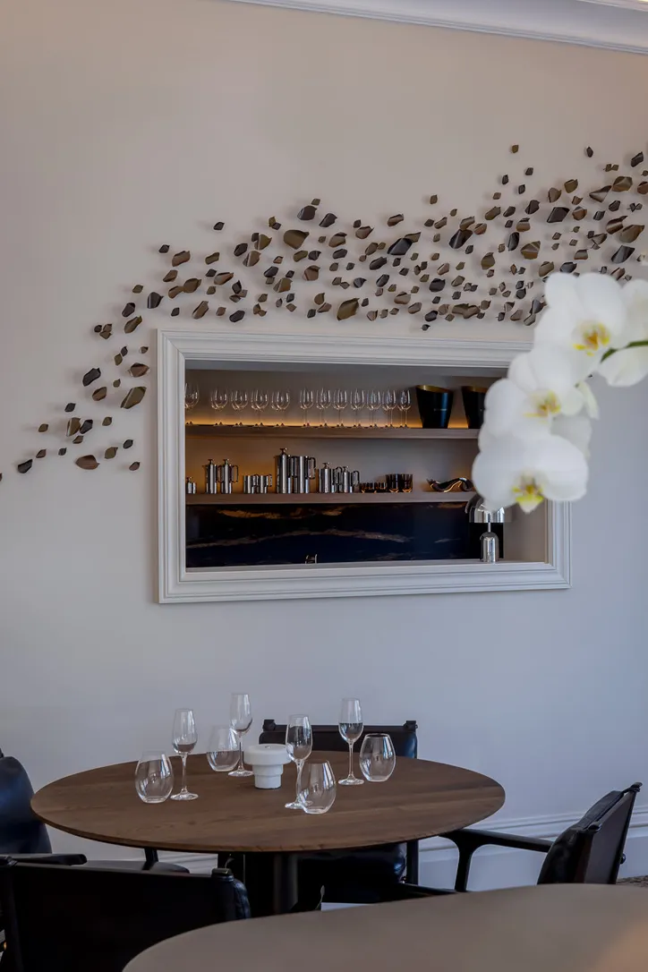 Spa refreshment nook with an orchid and a lit display niche, made-to-order detail