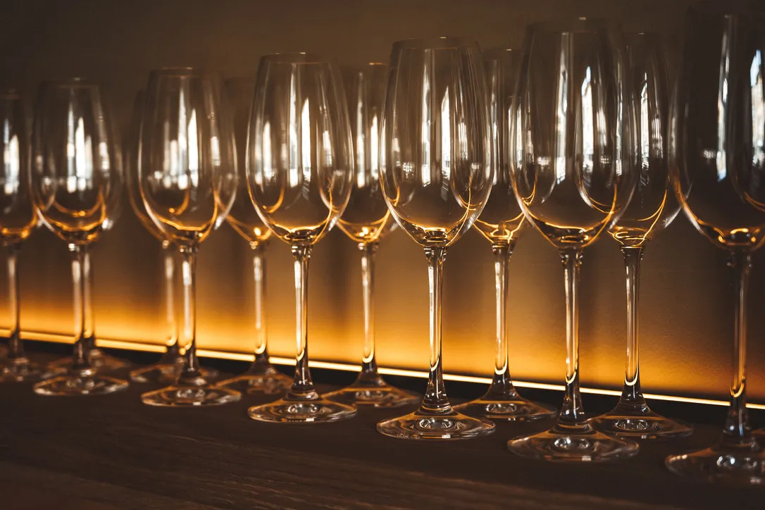 Champagne flutes on a lit bar shelf, Yorkshire spa interior design by Dean Heim & Co.