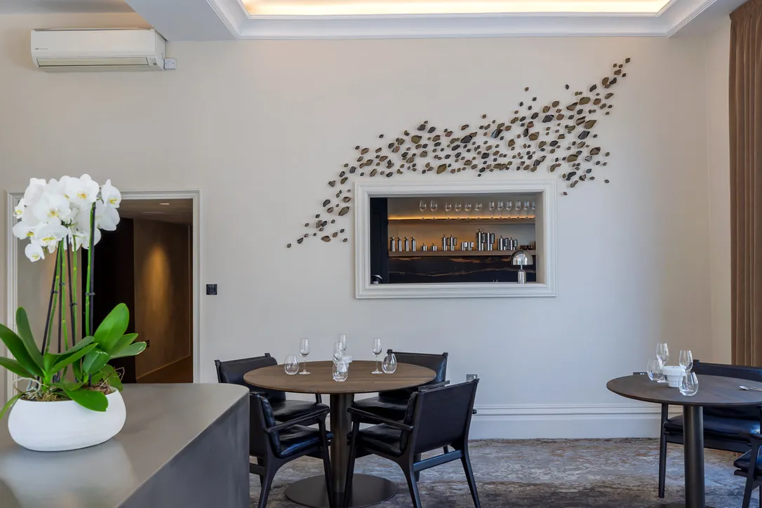 Spa interior design in Ilkley, Yorkshire: relaxation lounge with a lit drinks niche and sculptural wall art, by Dean Heim & Co.