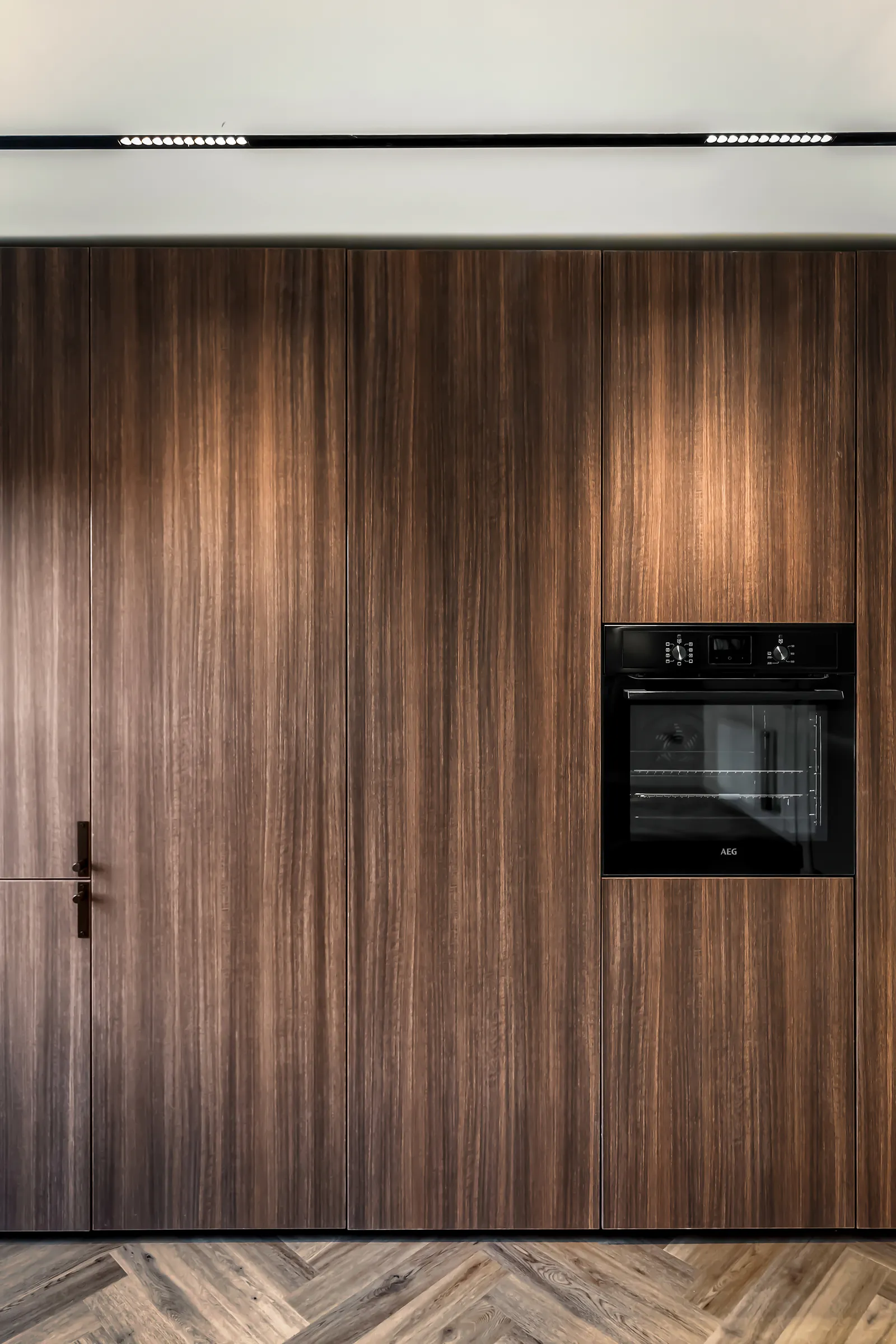 The Grove, walnut joinery wall with an integrated oven, Ilkley apartment